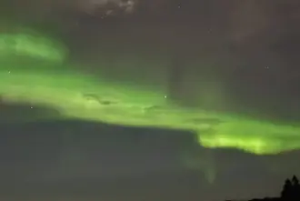 Northern Lights in green nearby Borgarnes town in Iceland.