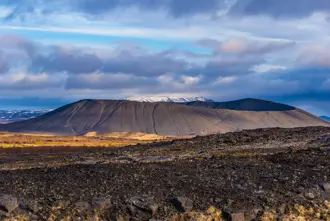 Hverfell volcanic crater on a bright cloudy day.