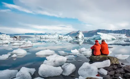 Tourists explore Jokulsarlon Glacier Lagoon in Iceland, surrounded by floating icebergs during a summer adventure.