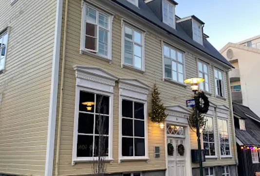 Fiskmarkaðurinn Fish Market Restaurant in Reykjavík, housed in a historic yellow building, offering a blend of traditional Icelandic cuisine and modern culinary techniques.