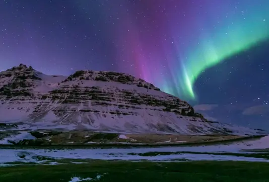 Pink Colorful Aurora Over White Mountains Iceland.
