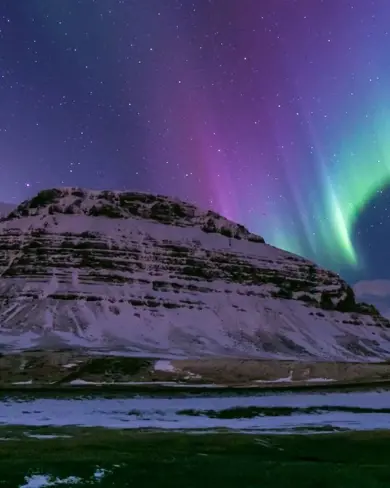 Pink Colorful Aurora Over White Mountains Iceland.