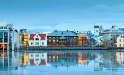 Beautiful winter twilight reflection of Reykjavik’s Althing parliament house and city skyline in Lake Tjörnin