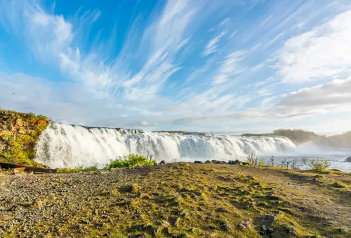 Faxi Waterfall under a blue sky.
