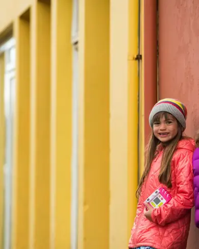 Two Little Girls Next To A Colorful House In Reykjavik Iceland Large