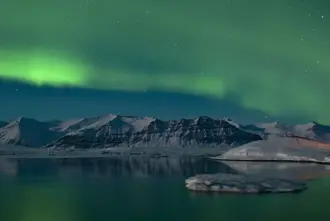 Northern Lights View Over Jokulsarlon Glacier Lagoon From Diamond Beach.