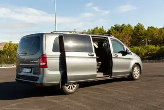 Private shuttle van for airport transfer with open door.