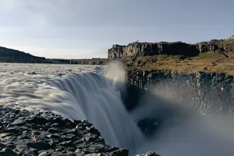 East side of Dettifoss waterfall with myst in the air.