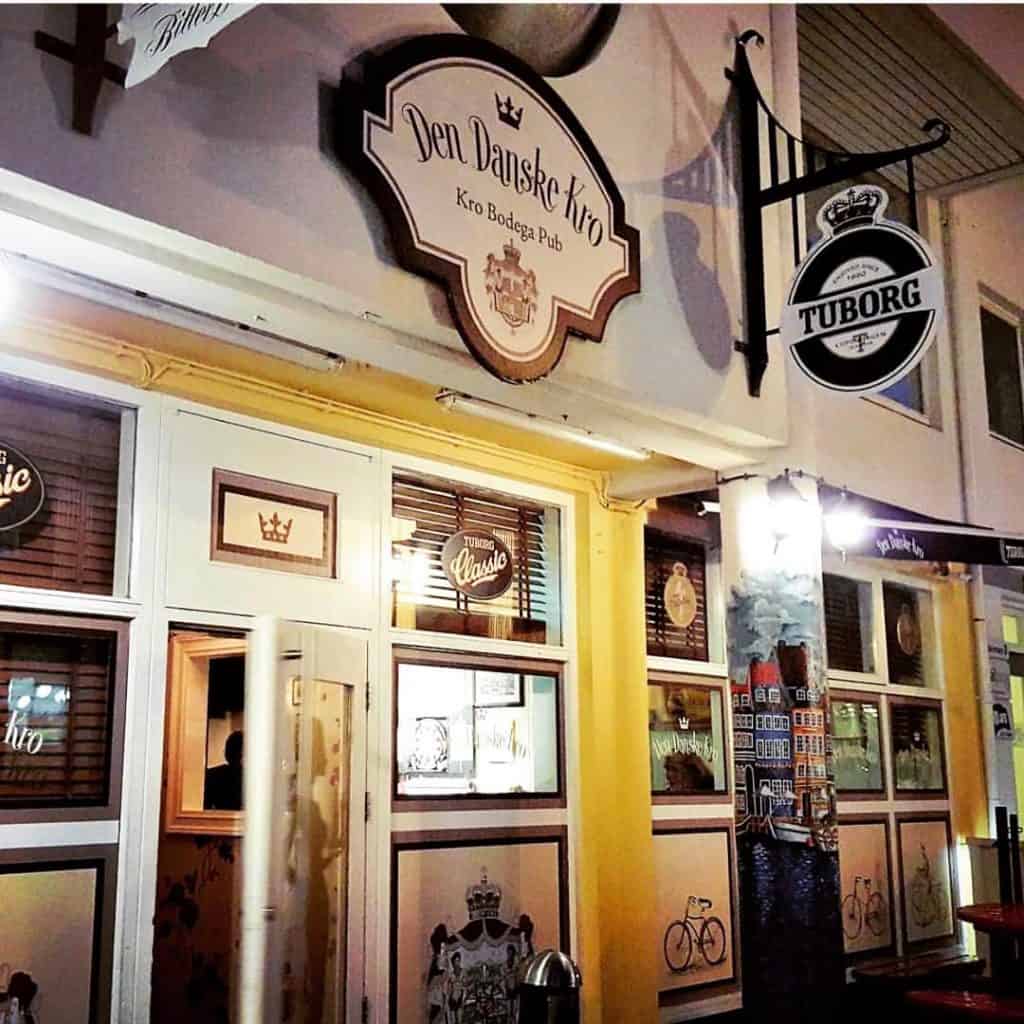 Entrance to Den Danske Kro Pub in Reykjavik, featuring cozy Danish-themed decor and Tuborg signage, offering a warm and authentic nightlife atmosphere.