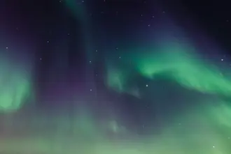 Norther Lights In Dark Night Sky Over Diamond Beach Iceland.