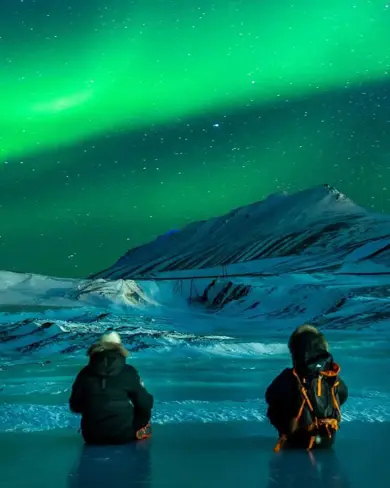 Sitting On Frozen Lake Watching Northern Lights Iceland.