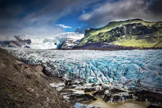 The massive Vatnajökull glacier with ice formations and rugged landscape in Iceland's national park.
