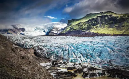 The massive Vatnajökull glacier with ice formations and rugged landscape in Iceland's national park.