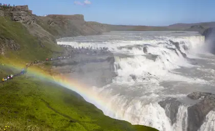 Gullfoss waterfall with a vibrant rainbow, part of Iceland's famous Golden Circle route.
