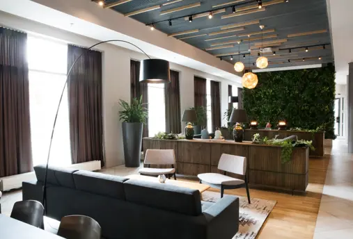  Fosshotel Reykjavik modern lobby area with warm natural elements and comfortable sofas and seating areas.