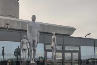 Metal sculpture art of standing humans outside Keflavik Airport in Iceland.