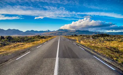 Iceland's ring road and mountain landscape under a blue sky on a south coast tour self drive in Iceland.