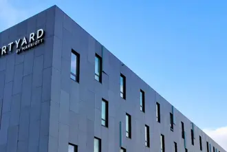Courtyard Reykjavík hotel nearby Keflavík Airport in Iceland under a blue sky.