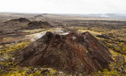 Aerial view of Eldvörp, a steaming geothermal area surrounded by moss-covered lava fields on the Reykjanes Peninsula in Iceland.