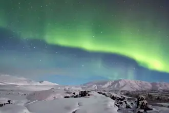 Green Northern Lights over Thingvellir in Iceland.