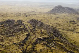 Expansive view of Eldvörp's volcanic terrain on the Reykjanes Peninsula, showcasing rugged lava fields and unique geological formations.