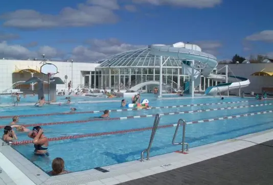 Árbæjarlaug geothermal swimming pool in Reykjavik featuring a slide and family-friendly amenities.