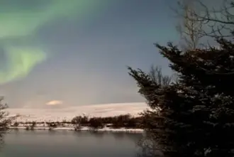 Northern Lights Over River In Hella Iceland.