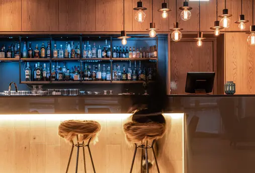 The lobby at Hotel Vík í Mýrdal offers a bar seating area and cozy lighting.