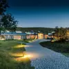 Beautifully illuminated exterior of Hotel Húsafell at dusk, blending seamlessly with Iceland’s natural landscapes.