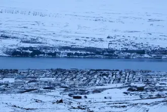 Aerial View of Akureyri and Eyjafjordur in winter covered in snow.