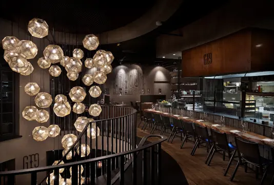 Elegant interior of Grill Market in Reykjavík, featuring modern lighting, stylish seating, and an open kitchen showcasing Icelandic culinary excellence.