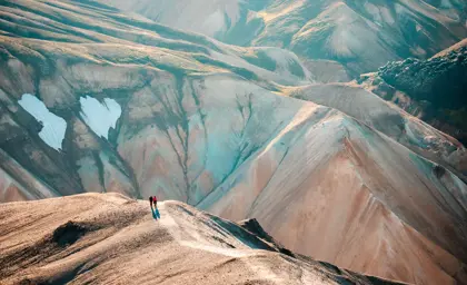 Aerial mountain view of two people enjoying views over a walley on a private superjeep tour.