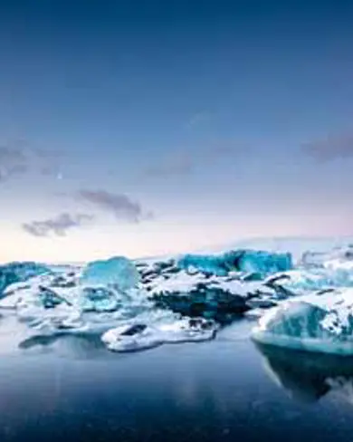 Icebergs floating in the serene waters of Jökulsárlón glacial lagoon in Iceland.