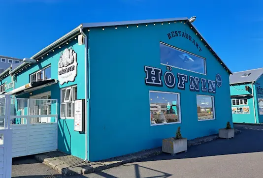 Höfnin Restaurant in Reykjavík, a charming turquoise building showcasing Icelandic maritime heritage, serving traditional Icelandic cuisine with a contemporary twist.