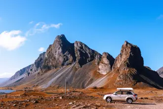 Iceland Stopover Car Under Mountain.