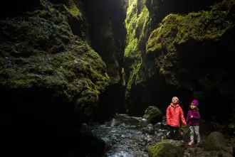 Two Kids Within Moss Covered Canyon Iceland Large