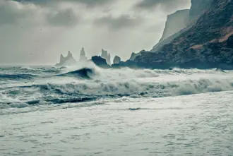 Reynisdrangar In Distance View From Vikurfjara Black Sand Beach Vik Iceland.