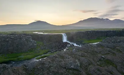 Waterfall cascading down cliff in Thingvellir National Park in Iceland.