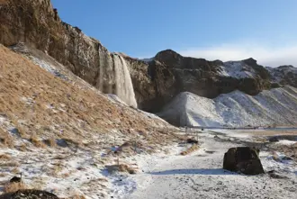 Hiking Path From Seljalandsfoss To Gljufrabui waterfall on a bright winter day in Iceland.